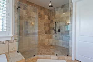 Primary bath with a large walk-in shower and a bathtub