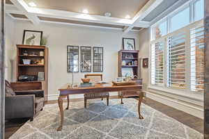 Office area featuring coffered ceiling, beamed ceiling, wood finished floors, healthy amount of natural light, and recessed lighting