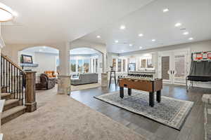 Game room with wood finish floors, recessed lighting, french doors leading to the backyard and arched walkways