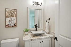 Half bath featuring vanity and toilet