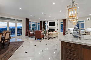 Living room with a fireplace, recessed lighting, and a chandelier