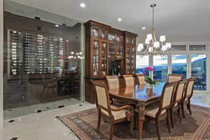 Dining room with a chandelier, light tile patterned floors, and recessed lighting