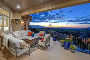 Patio terrace at dusk featuring a patio area and an outdoor living space