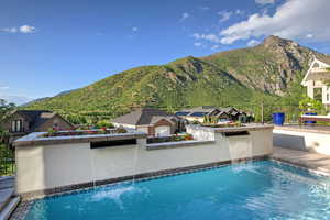 Swimming pool with a mountain view and a patio area