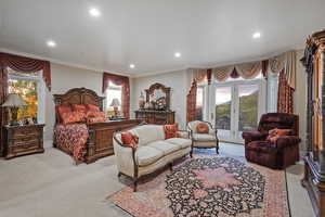 Carpeted bedroom with access to exterior, crown molding, recessed lighting, and multiple windows