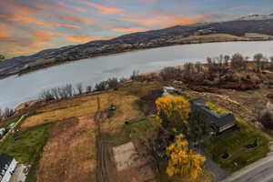 Aerial view of property and surrounding area featuring a water and mountain view
