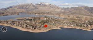 Aerial view of property's location with a water and mountain view