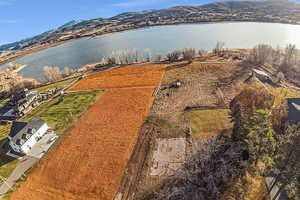 Aerial view of property and surrounding area featuring a water and mountain view