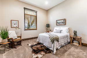Carpeted bedroom featuring baseboards