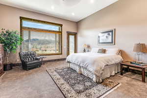 Carpeted bedroom featuring access to outside and ceiling fan