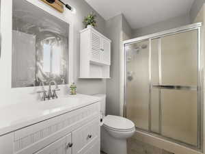 Bathroom featuring vanity and a stall shower