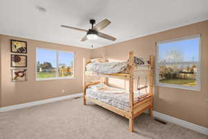 Bedroom with crown molding, carpet, and ceiling fan