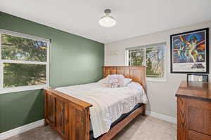 Bedroom with light colored carpet