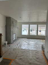 Unfurnished living room featuring a textured ceiling