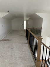 Hall featuring lofted ceiling and a textured ceiling