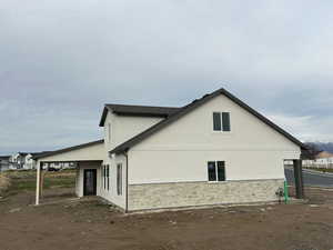 View of home's exterior with stucco siding and stone siding