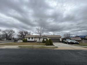 Ranch-style home with concrete driveway and a garage