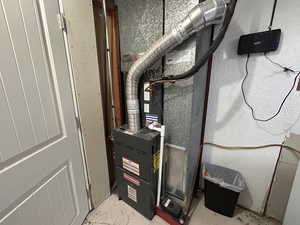 Utility room featuring heating unit
