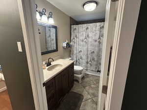 Bathroom featuring vanity, a shower with shower curtain, and light tile patterned floors