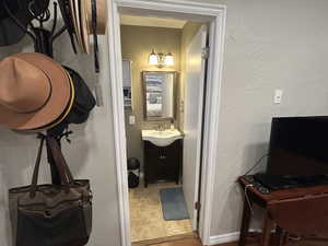 Bathroom featuring vanity and a textured wall