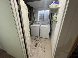 Washroom featuring washing machine and dryer