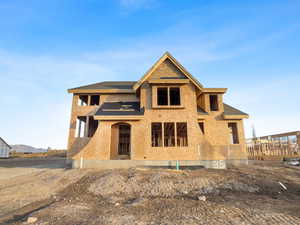 View of front of home with roof with shingles