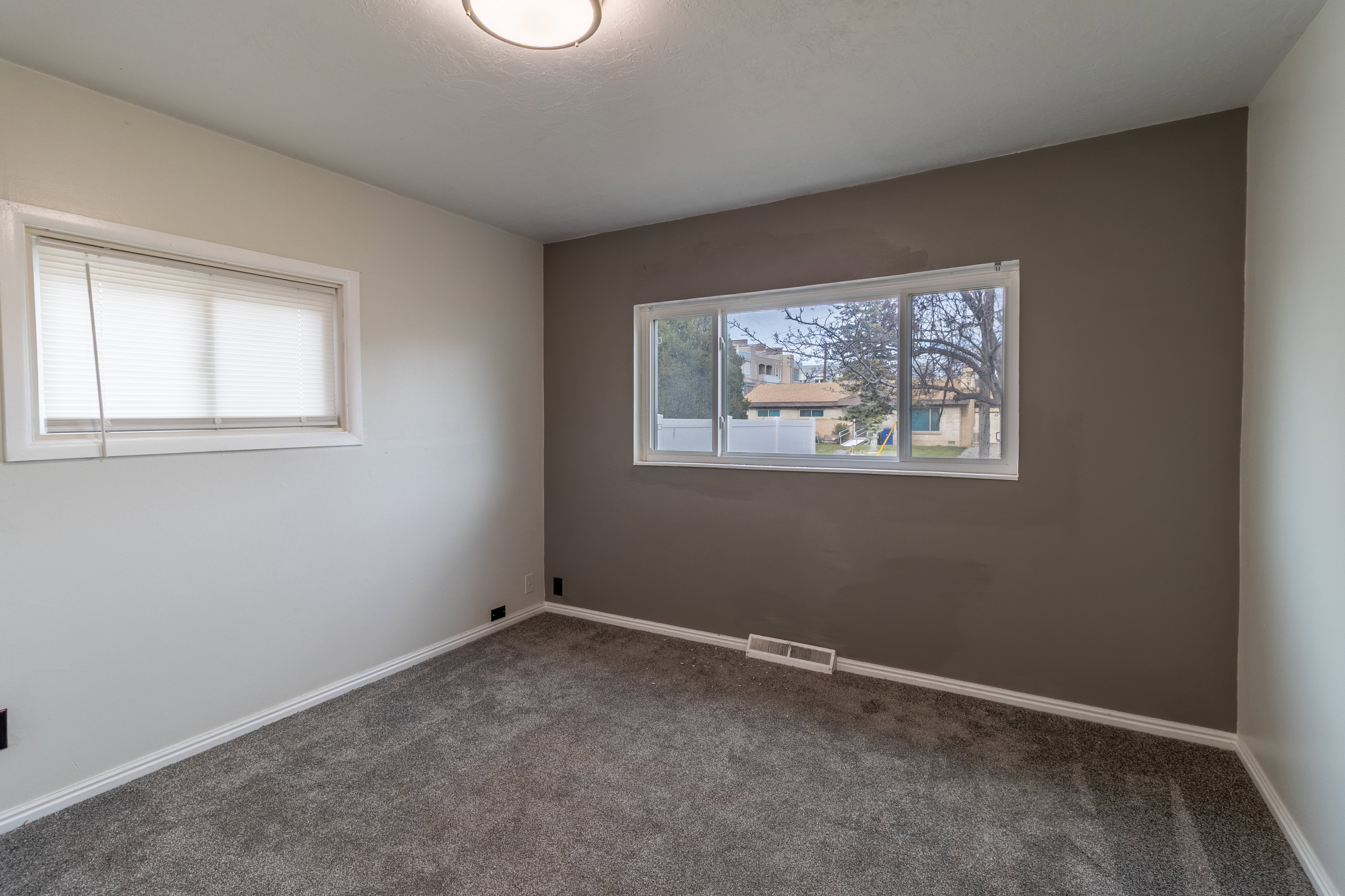 Empty room featuring baseboards and carpet flooring