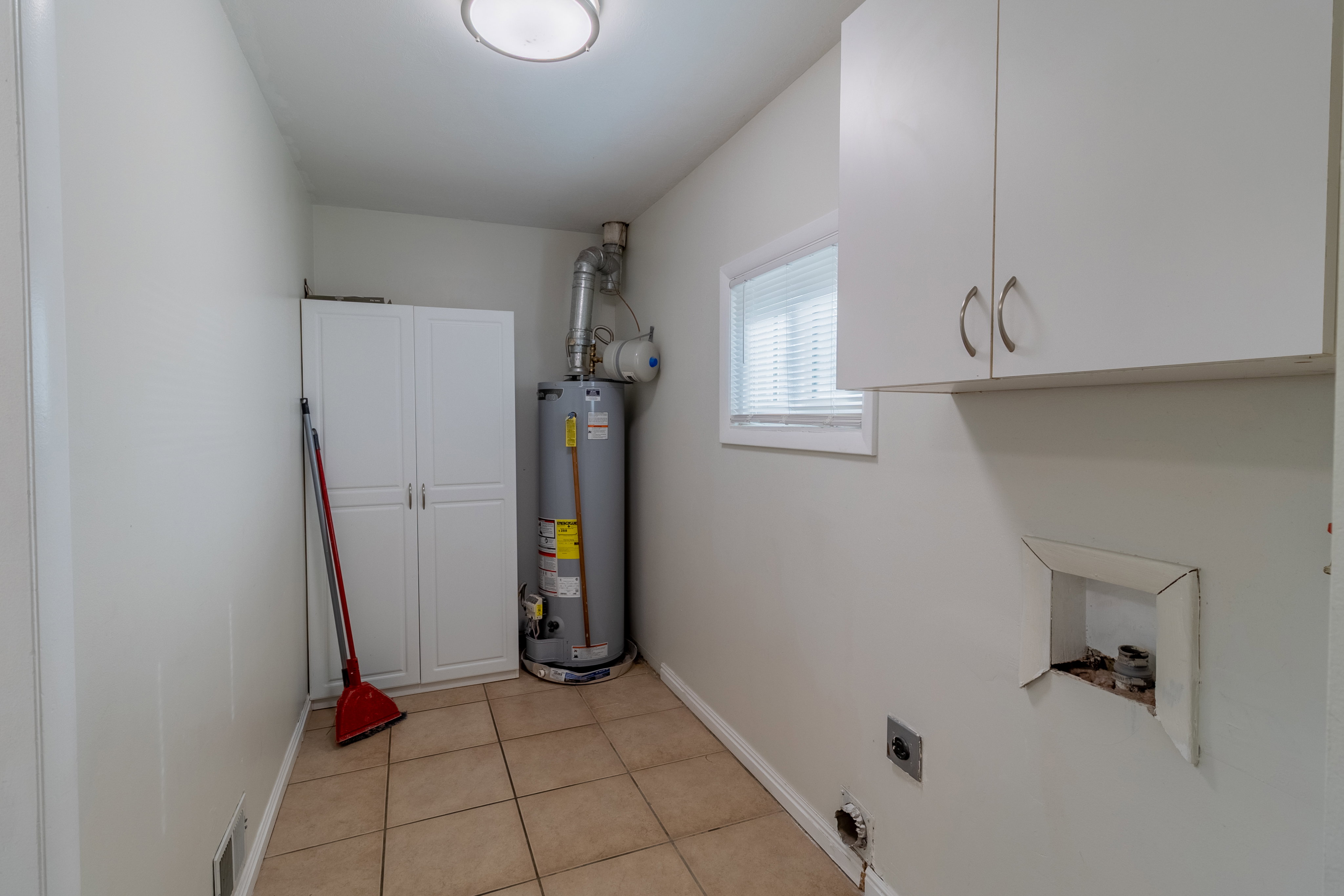Utility room with gas water heater