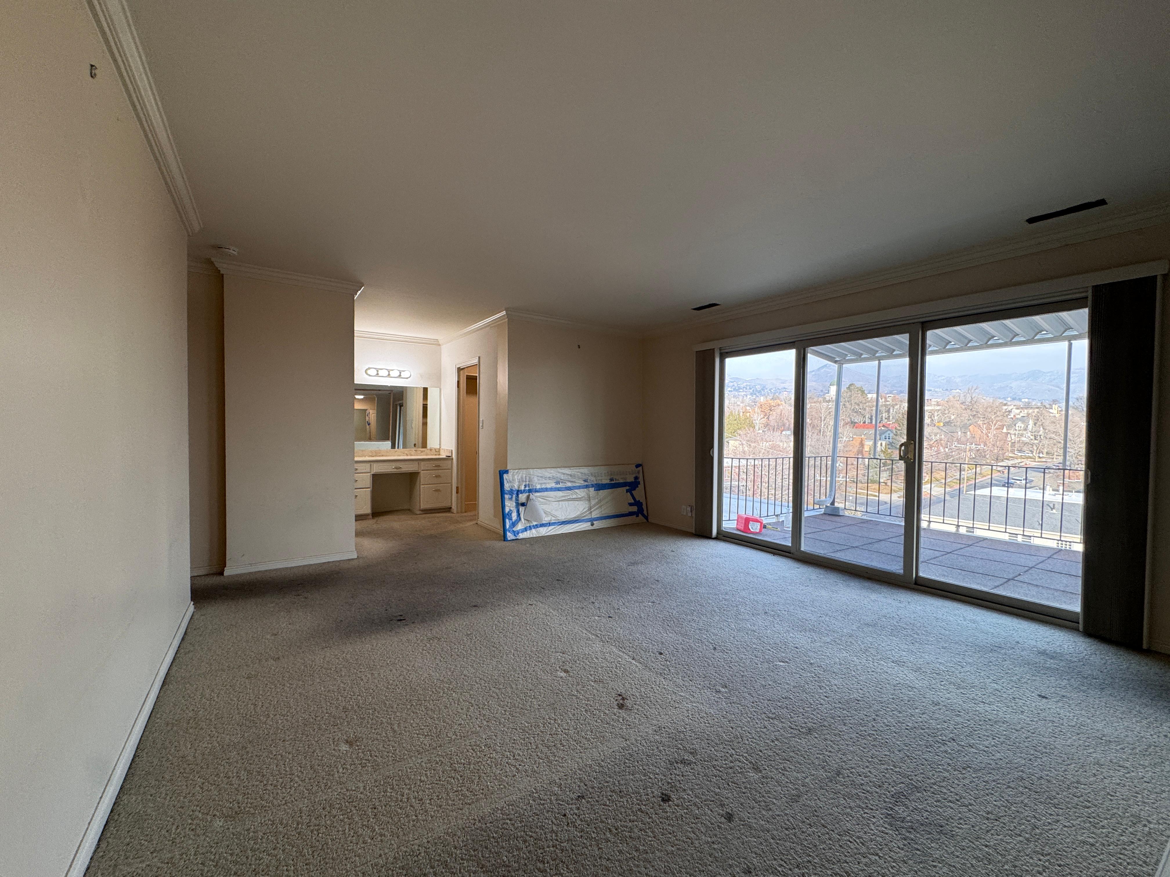 Unfurnished living room with ornamental molding and carpet floors