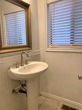 Bathroom featuring light tile patterned floors and baseboards