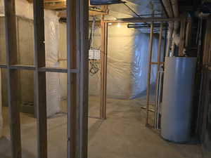 Unfinished basement featuring water heater