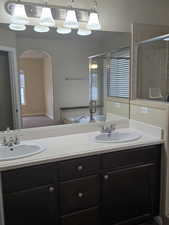 Bathroom with double vanity and a stall shower