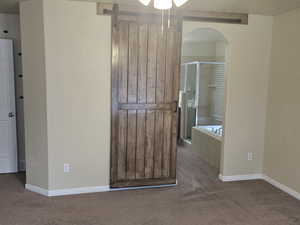 Bathroom with carpet flooring, a stall shower, and ceiling fan