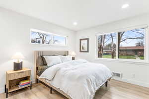 Bedroom with light wood-type flooring and recessed lighting