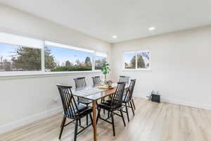 Dining room featuring light wood finished floors and recessed lighting