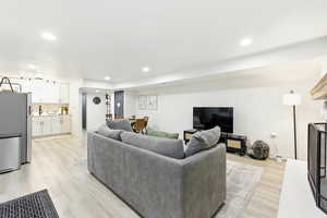 Living room featuring light wood-style flooring and recessed lighting