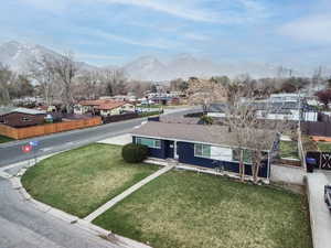 View of front of home featuring a residential view, a mountain view, and a porch