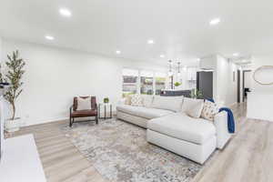 Living area featuring light wood-style flooring and recessed lighting