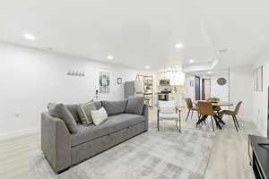 Living room with recessed lighting and light wood-style flooring