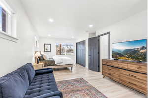 Bedroom featuring a closet, light wood-type flooring, and recessed lighting