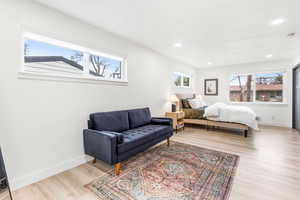 Bedroom featuring multiple windows, light wood-style floors, and recessed lighting