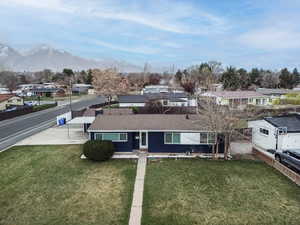 View of front facade with a porch, a residential view, a mountain view, and a shingled roof