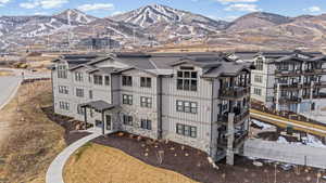 View of front of property with stone siding, a mountain view, and board and batten siding