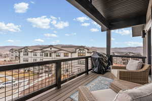 Wooden terrace featuring a grill, a mountain view, and a residential view