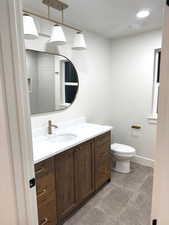 Full bath with vanity, a shower, and recessed lighting