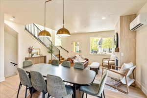 Dining area featuring light wood finished floors, a textured ceiling, and recessed lighting