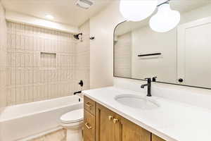 Full bathroom featuring vanity, shower / bathtub combination, and recessed lighting