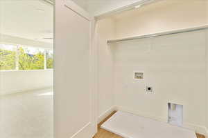 Laundry area with washer hookup, electric dryer hookup, and light colored carpet