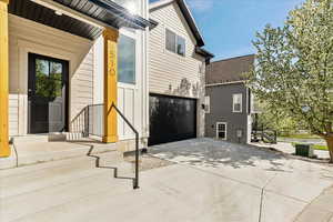 View of home's exterior with concrete driveway and a garage