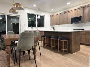 Dining space featuring light wood finished floors and recessed lighting